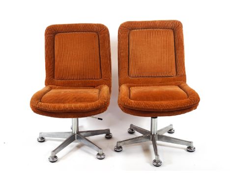 Two corduroy chairs (NB to be sold as a collectors item only), on five splay metal swivel stands, 90cm high