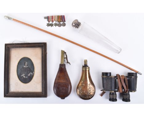 A mixed lot including a Thornhill &amp; Co silver mounted glass scent bottle, two powder flasks, a pair of brass mounted bino