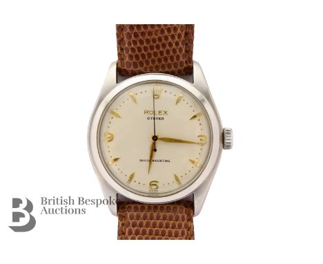 Gentleman's 1960's Rolex Oyster wrist watch. The watch having a champagne face with gold baton and Arabic markers with Rolex 