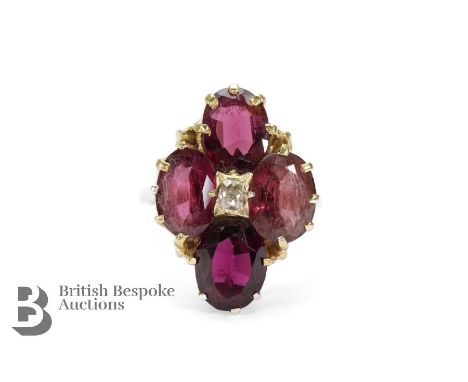 Antique 9ct yellow gold pink garnet and diamond ring. The ring set with four pink garnets surrounding a central rose-cut diam
