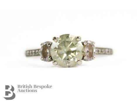 14ct white gold natural fancy diamond ring. The ring set with a 1.25ct natural fancy yellowish green diamond, SI2 flanked by 