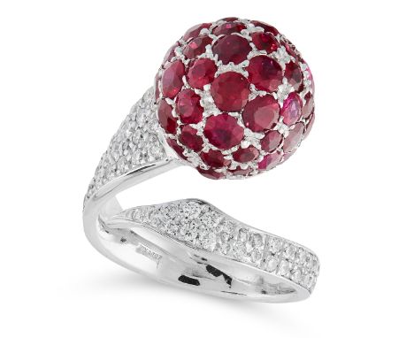 A RUBY AND DIAMOND DRESS RING in 18ct white gold, in cross over open band design, set with a sphere, pave set with round cut 