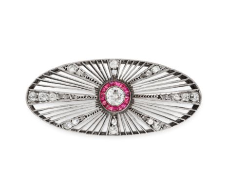 A RUBY AND DIAMOND BROOCH in oval, open framework design, set with a central round cut diamond of approximately 0.45 carats i
