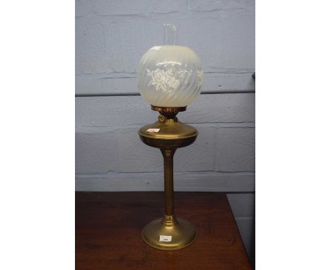 Brass oil lamp with floral glass shade