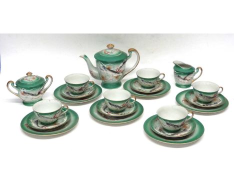 A mid 20th century Japanese lithophane teaset comprising teapot, sugar bowl milk jug and six cups and saucers with side plate