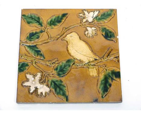 Minton &amp; Hollins tile, the brown ground decorated with majolica type glazes with a bird on a branch
