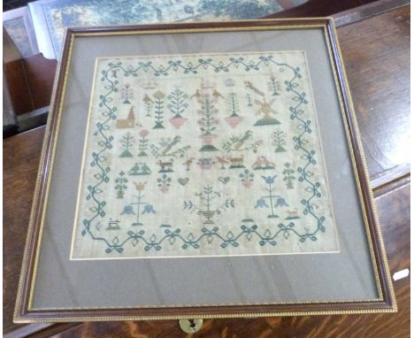 Georgian needlework sampler decorated with various plants, buildings and animals surrounded by a sinuous floral border, conte