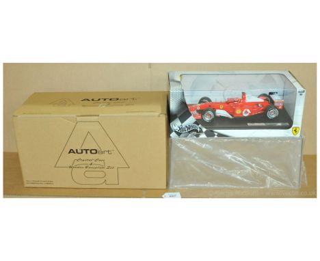 A boxed pair to include Hot Wheels B6200 Ferrari F2004 'Michael Schumacher' with Autoart Crystal Case &amp; Wooden Baseplate 