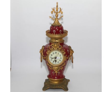 French red porcelain and gilt mounted decorative mantel clock with lion ring handles 