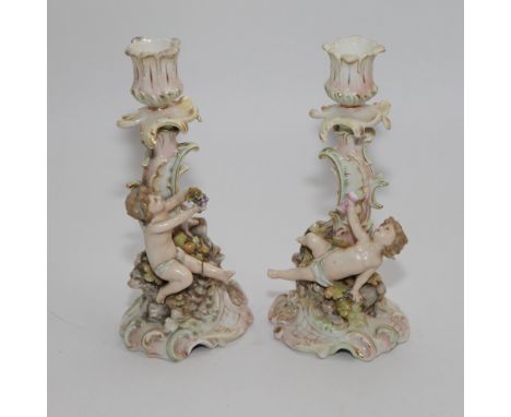 Pair of continental cherub candlesticks 20cm high (a/f)  Condition - one cherub has had leg off and there is glue holding the