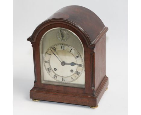 Arched top mahogany Edwardian mantel clock with silvered face and dial with subsidiary slow fast dial above, 11" tall 
