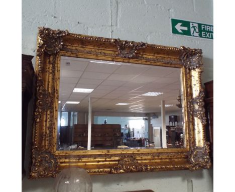 Ornate French style gilt swept mirror with bevelled edge, 46" wide x 36" high - can be hung landscape or portrait