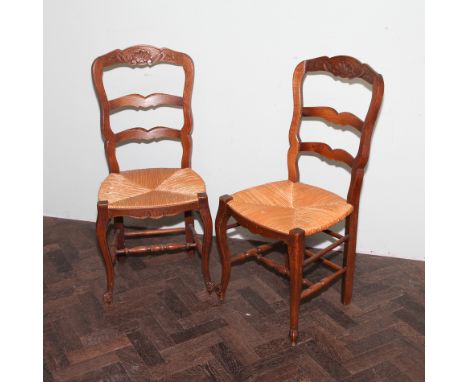 Set of 7 French oak ladder back dining chairs standing on cabriole legs with rush seats, one slightly damaged 