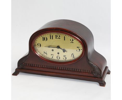 1920's mahogany mantel clock with unusual elongated oval face, 3 winding holes.  19" wide x 11" high