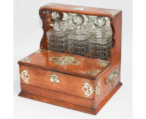 Victorian oak and brass bound 3 bottle decanter tantulus with key.  13.5" wide, 3 matching square cut bottles.  Crib board an
