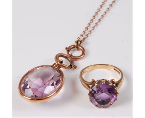 A 9ct amethyst ring and an amethyst pendant and long chain, the round claw set amethyst ring, hallmarked 1965, size N-O, case