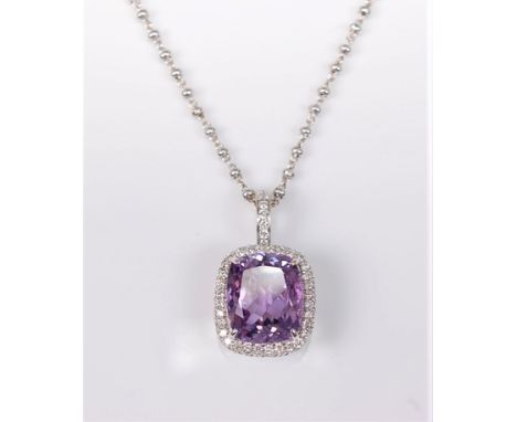 An 18ct white gold amethyst and white hardstone pendant necklace, the modified cushion cut amethyst, approx. 11.5 x 9.5mm, su