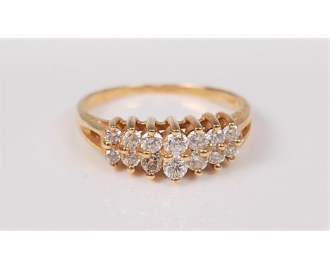 A two row diamond ring, the two rows of small round brilliant cut diamonds, total estimated approx. 0.14cts, in a raised step