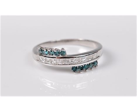 A bi-colour diamond ring, the small treated blue-green round brilliant cut diamonds set to either side of a channel of prince