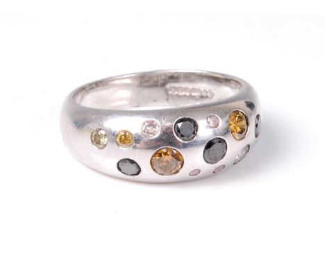 An 18ct multi-coloured diamond ring, the broad tapered band interspersed with a white, yellow and deep blue/black diamonds (p