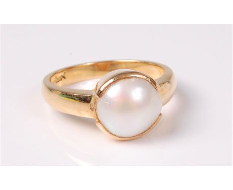 A pearl ring, the single button pearl, approx. 9.8mm diameter, in a rubover setting and plain slightly tapered band, stamped 