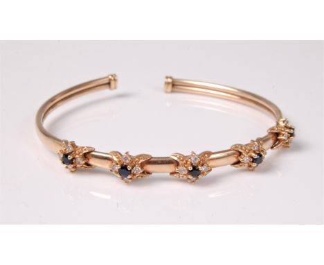 A blue and white hardstone cluster bangle, the five small blue hardstones (probably sapphires) surrounded by small white hard
