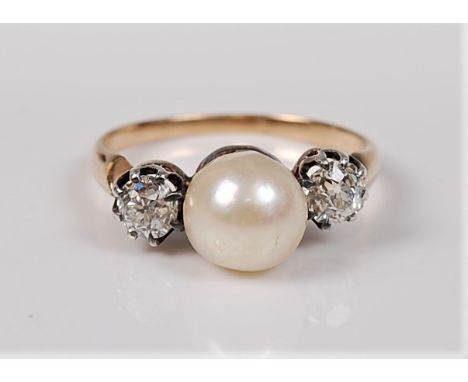 A cultured pearl and diamond ring, the central pearl, approx. 7.4mm diameter, set to either side with an old brilliant cut di