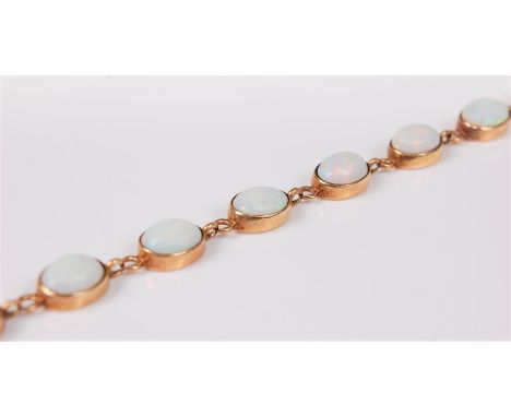 A 9ct opal bracelet, the thirteen oval opal cabochons in rubover mounts, with small intercontecting rings, with clasp stamped