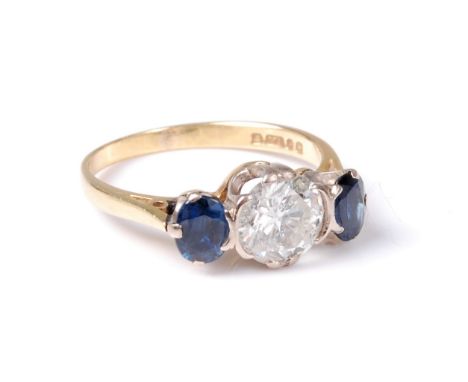 An 18ct diamond and sapphire ring, the round brilliant cut diamond, estimated approx. 0.98cts, in a double claw and tension s