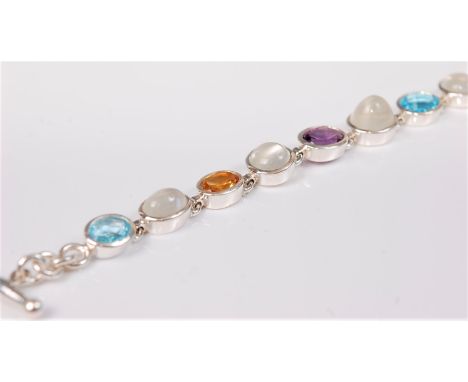 A silver and multi gemset bracelet, the mixed cut gemstones to include topaz, moonstone, citrine, amethyst, garnet and tourma