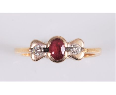 A ruby and diamond ring, the central oval ruby set to either side with a small round brilliant cut diamonds, total estimated 