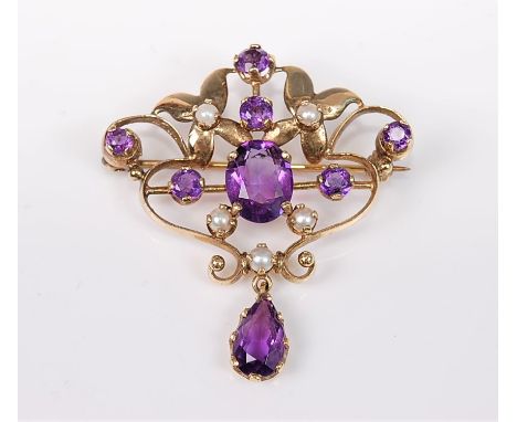 An Edwardian style 9ct amethyst and cultured pearl brooch/pendant, the oval and round amethysts set with two small flowers wi