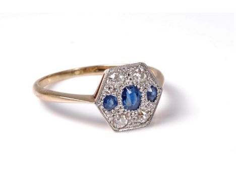 An early 20th century sapphire and diamond ring, the hexagonal plaque style ring set with three oval sapphires and four round