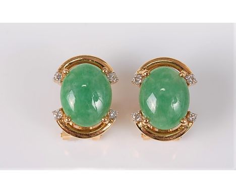 At pair of 18ct jade and diamond earstuds, the oval jade cabochons, approx. 11 x 8.5mm, in a four claw mount, set with a smal