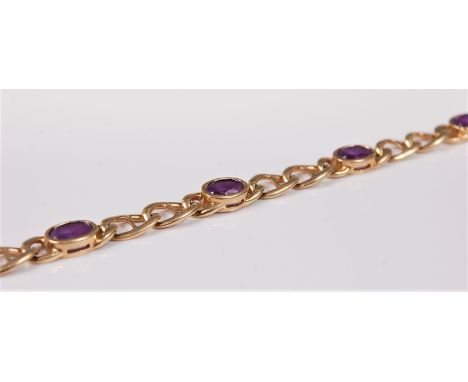 A 9ct amethyst bracelet, the six oval amethysts, approx. 6.8mm long, in rubover mounts and interspaced with short lenghts of 