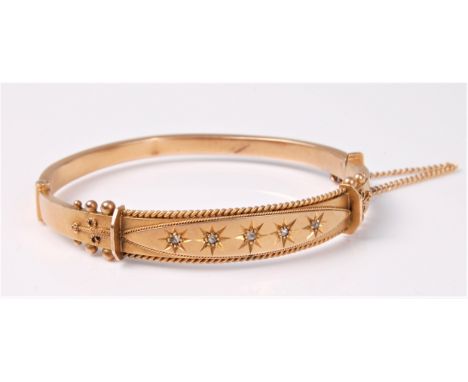 A diamond bangle, the slightly tapered bangle with five gyspy set diamond highlights in a navette shaped plaque, with rope tw