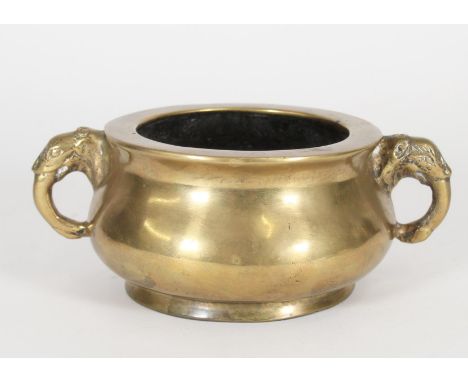 Chinese bronze censer, the flared rim leading to squat body with cast elephant head handles, with apocryphal Xuande mark to b