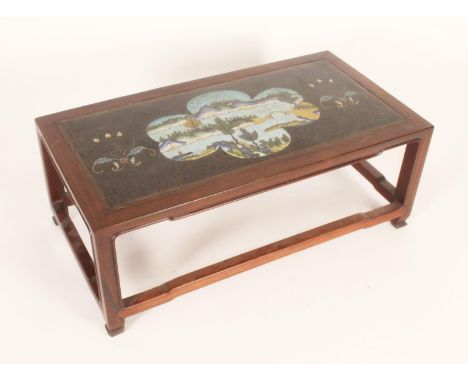 Chinese hardwood and cloisonne table stand, the hardwood frame inset with a cloisonne panel decorated with a landcape scene b