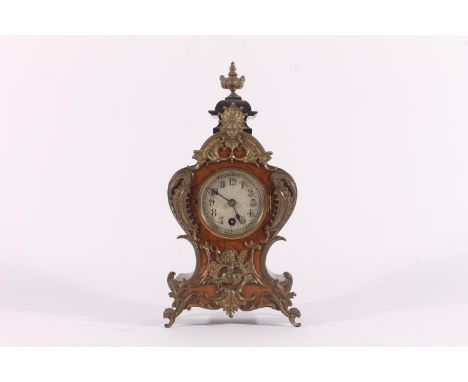 German Lenzkirch mantel clock, early 20th century, the rococo shaped case with urn finial, applied brass mask and scroll deco