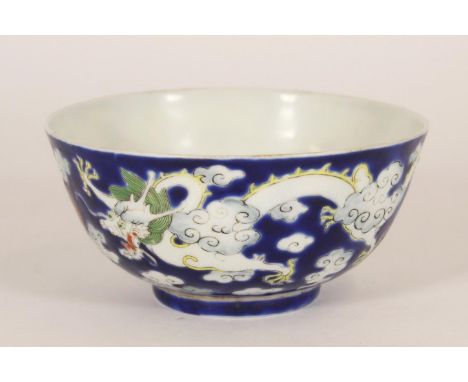 Chinese white dragon bowl, late Qing period, the white dragon with green mane chasing a red flaming pearl amongst clouds, all