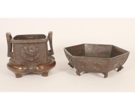 Japanese bronze censer, with looped handles over a dragon and dragon-turtle decorated body, together with another Japanese ce