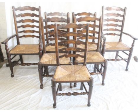 Set of five oak ladder back dining chairs raised on turned supports and rushed seat with a pair of matching carvers (7).