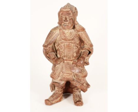 Chinese red clay figure of a warrior in traditional armour, holding a scroll in left hand, H33cm.