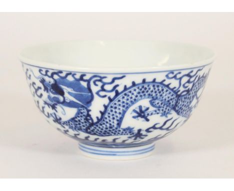 Chinese porcelain dragon bowl, late Qing Guangxu period, the body decorated in underglaze blue with a five claw dragon chasin