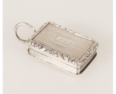 Antique George IV silver vinaigrette of rectangular form having engine turned decoration and relief chased scroll edge by Nat