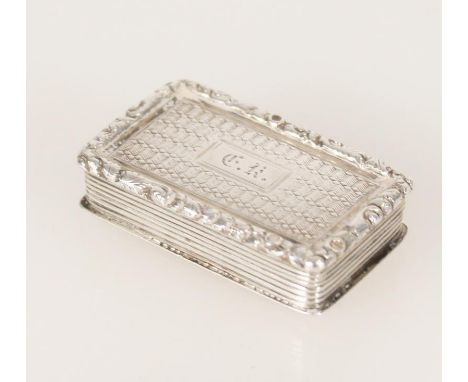 Antique George VI silver vinaigrette of rectangular form having engine turned decoration, reeded edges and relief chased flor