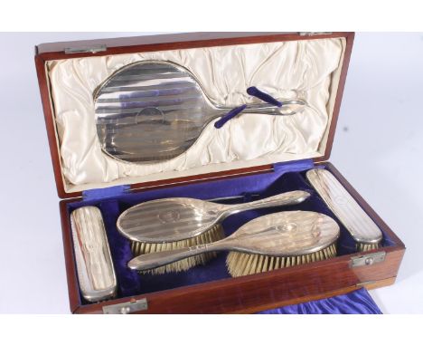 Geo.V silver dressing table set, of four brushes, hand mirror and comb, all with lined engine turned decoration, Williams Ltd