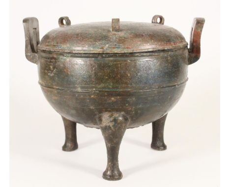 Chinese Archaic style bronze food vessel, with square handles, the round body and domed lid raised on tripod feet, intricatel