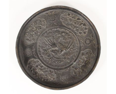 Chinese thin bronze dish, cast in relief with a border of foliate panels framing a central phoenix amongst clouds with auspic