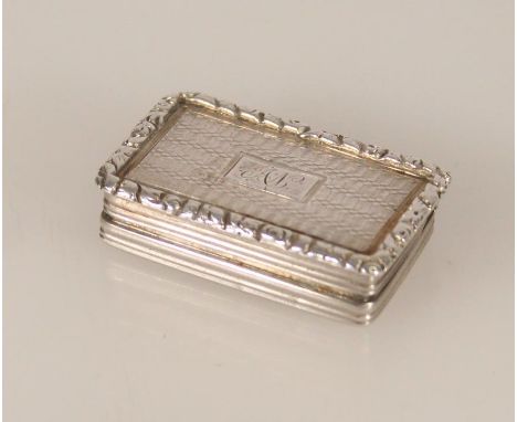 Antique silver vinaigrette of rectangular form having engine turned decoration, reeded edges and relief chased floral pattern